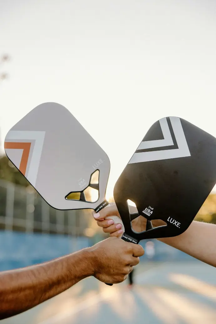 A couple of people that are holding some tennis rackets